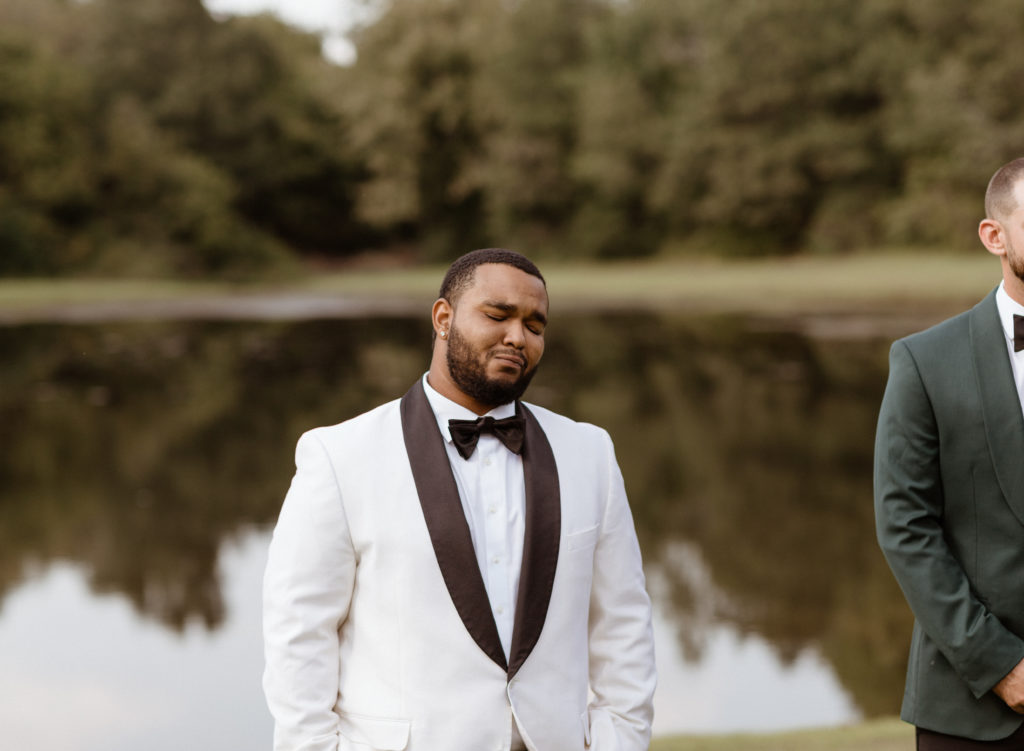 Groom sees bride for the first time at their wedding in Charlotte, North Carolina