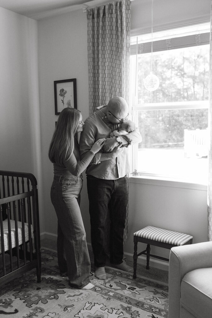 Dad holding newborn at newborn session in Jacksonville North Carolina