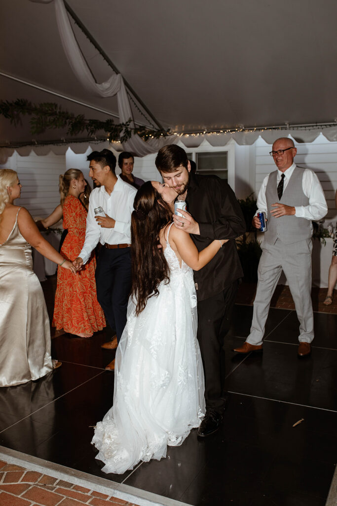 Bride and groom dancing joyfully with guests at a North Carolina outdoor wedding reception