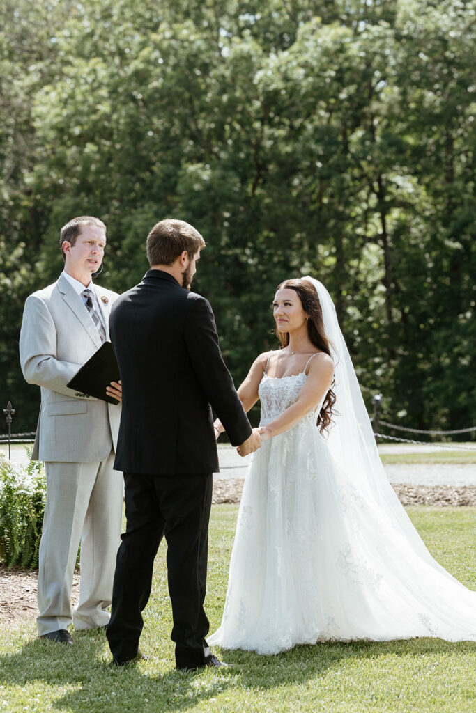Bride and groom sharing a candid smile during their ceremony in Wilmington, North Carolina