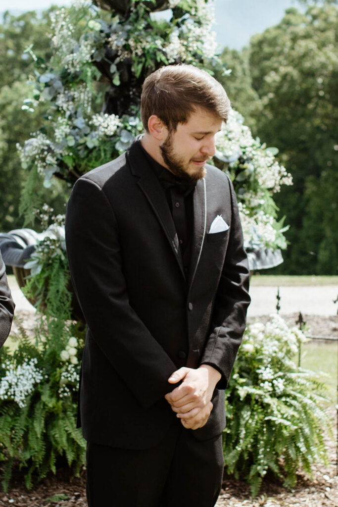 Groom crying while watching bride walk down the aisle at a North Carolina wedding