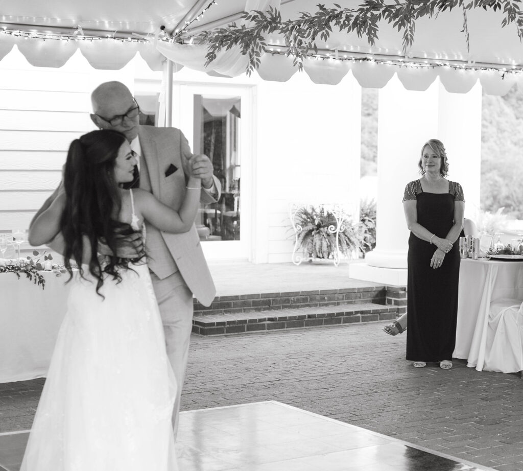 Emotional father-daughter dance at a documentary wedding photographed in Wilmington, NC