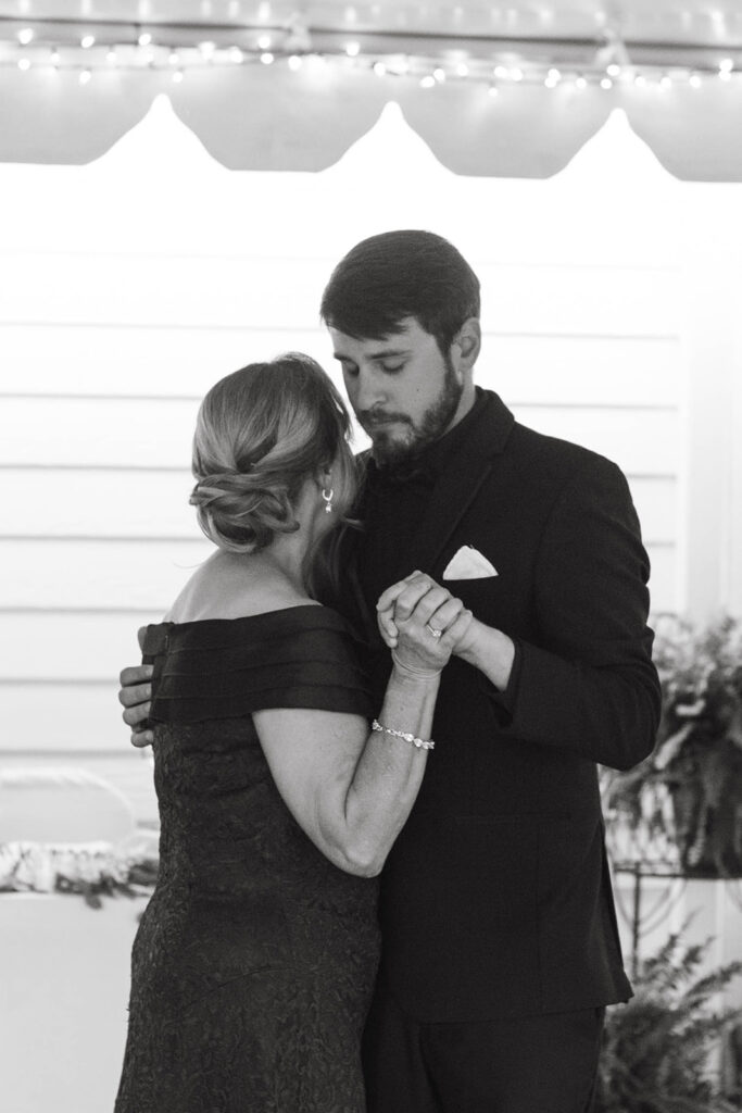 Emotional mother-son dance at a documentary wedding photographed in Wilmington, NC