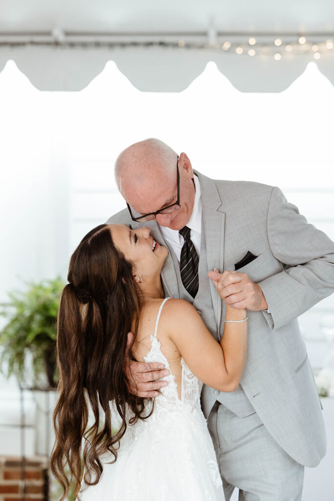 Emotional father-daughter dance at a documentary wedding photographed in Wilmington, NC