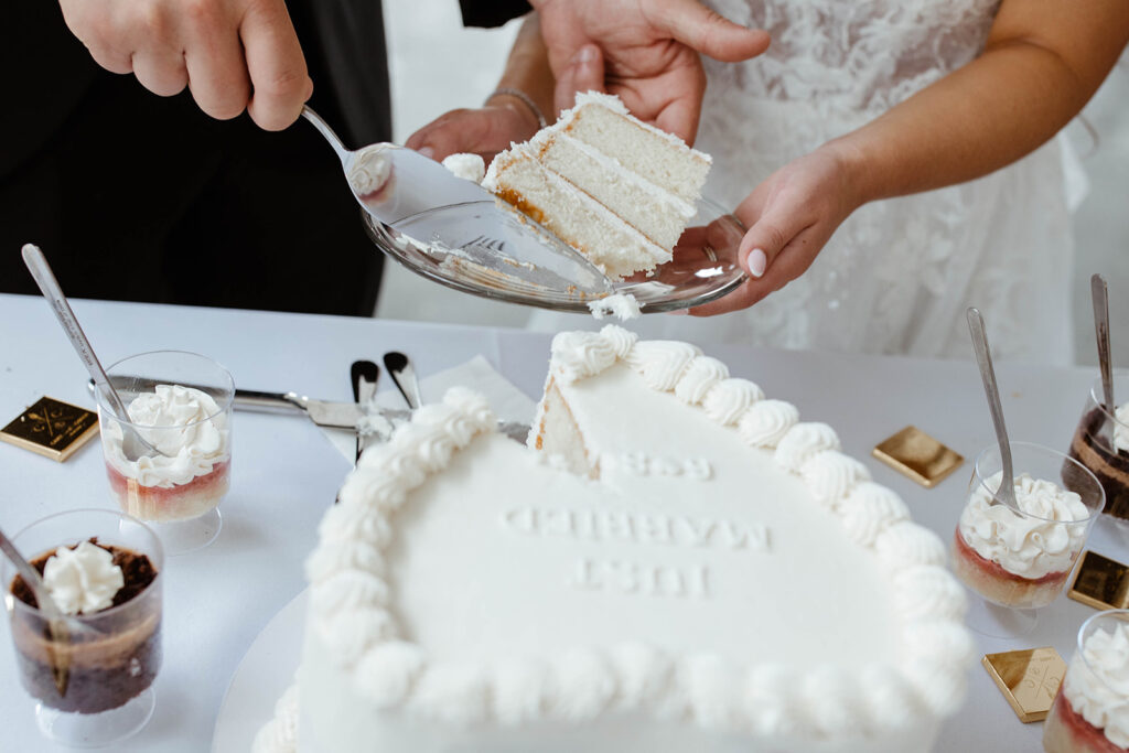 couple cuts wedding cake at north carolina wedding