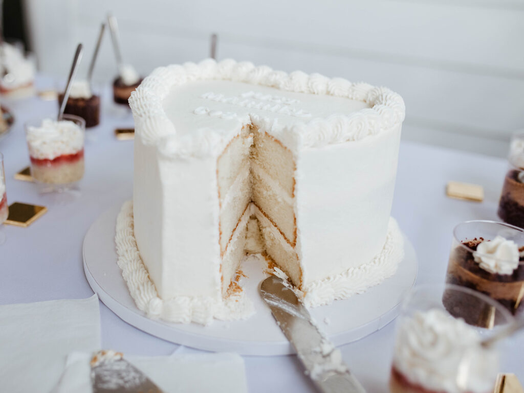 couple cuts wedding cake at north carolina wedding