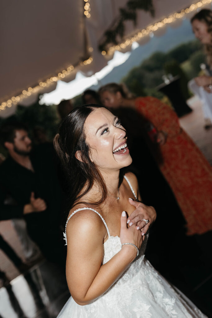 Bride and groom dancing joyfully with guests at a North Carolina outdoor wedding reception