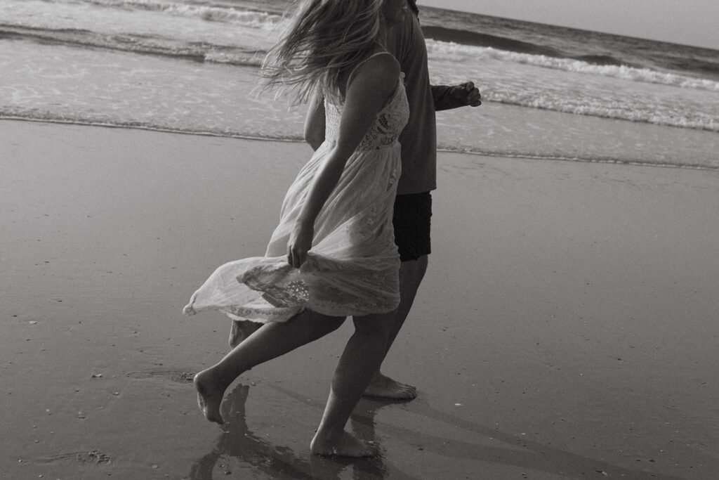 Candid couple photo during a sunrise session with Wrightsville Beach couples photographer